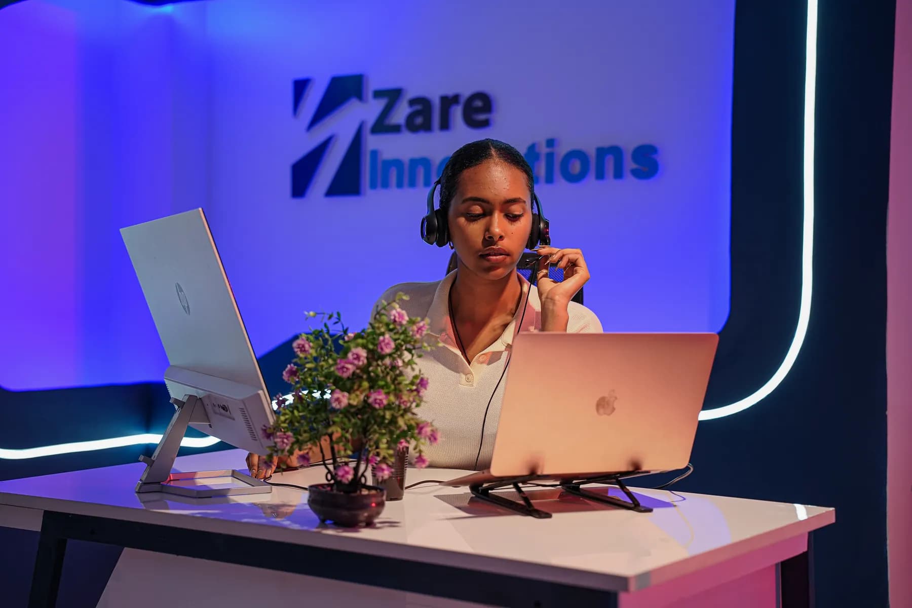 A Zare operations specialist working at her desk with a headset